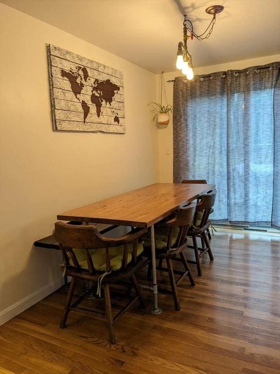 dining area with dark wood-type flooring