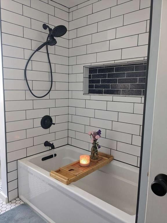 bathroom with tile patterned flooring, tiled shower / bath combo, and tile walls