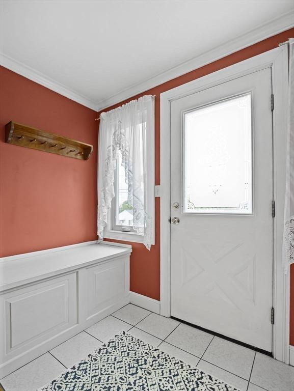 11 View St, Dracut, MA 01826 - entrance foyer with light tile patterned floors, baseboards, and ornamental molding
