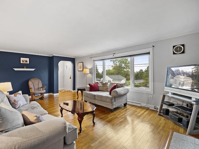 11 View St, Dracut, MA 01826 - living area with arched walkways, ornamental molding, a baseboard heating unit, wood-type flooring, and baseboards