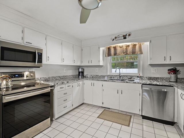 11 View St, Dracut, MA 01826 - kitchen with stainless steel appliances, a sink, light stone counters, white cabinetry, and light tile patterned floors