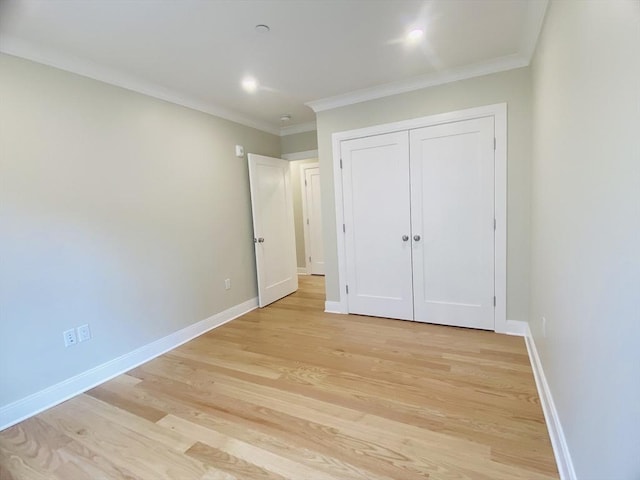15 Yuill Cir Unit 3, Boston, MA 02136 - unfurnished bedroom featuring light wood-type flooring, crown molding, baseboards, and a closet