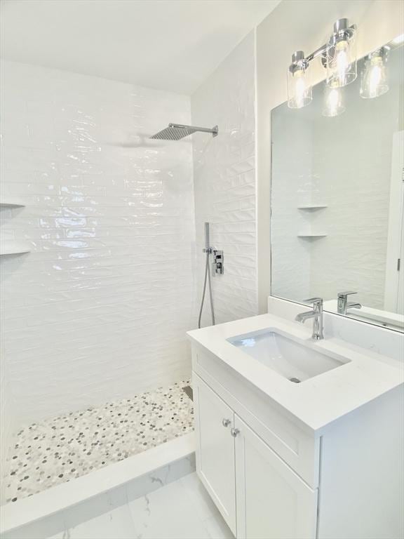 15 Yuill Cir Unit 3, Boston, MA 02136 - bathroom featuring a tile shower, vanity, and marble finish floors