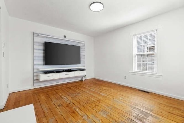 18 Anderson St, Lowell, MA 01852 - unfurnished living room featuring light wood-type flooring and baseboards
