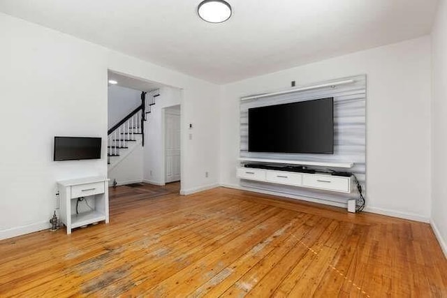 18 Anderson St, Lowell, MA 01852 - unfurnished living room featuring stairway, baseboards, and light wood finished floors
