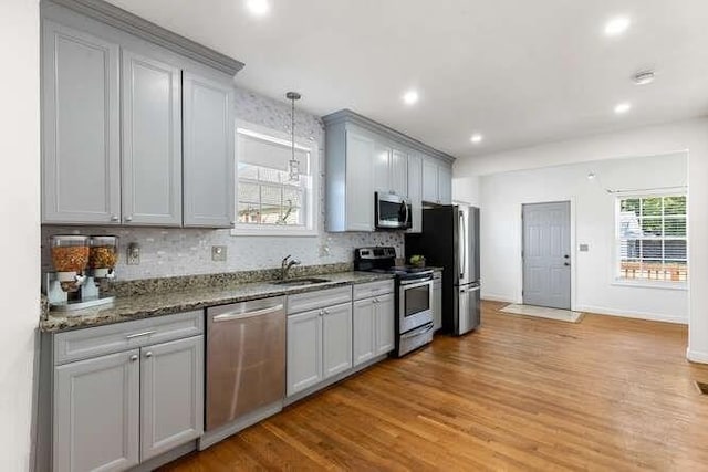 18 Anderson St, Lowell, MA 01852 - kitchen featuring stainless steel appliances, gray cabinets, decorative backsplash, light wood-type flooring, and recessed lighting