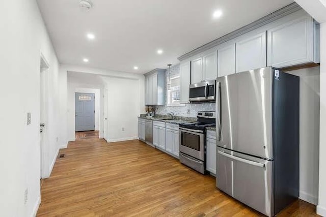 18 Anderson St, Lowell, MA 01852 - kitchen featuring stainless steel appliances, a sink, backsplash, recessed lighting, and baseboards