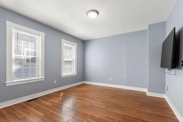 18 Anderson St, Lowell, MA 01852 - unfurnished room featuring wood finished floors and baseboards