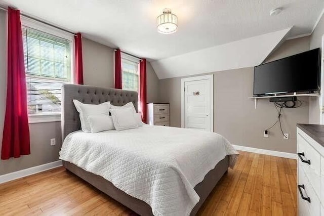 18 Anderson St, Lowell, MA 01852 - bedroom with baseboards, vaulted ceiling, and light wood finished floors