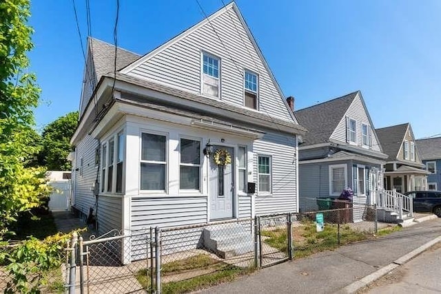 18 Anderson St, Lowell, MA 01852 - view of front of home featuring a gate, a fenced front yard, and entry steps