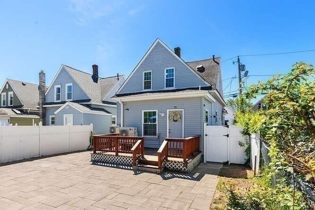 18 Anderson St, Lowell, MA 01852 - back of property with a gate, a fenced backyard, a patio area, and a deck