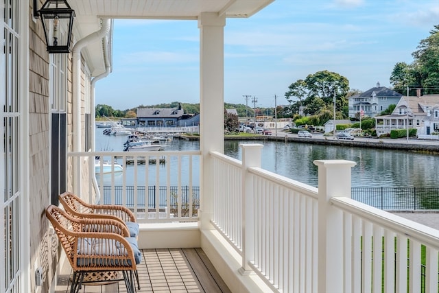 balcony featuring a water view