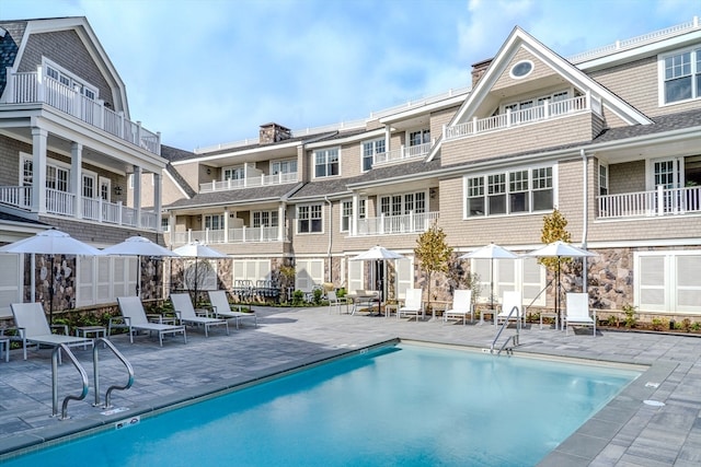 exterior space featuring a community pool and a patio area