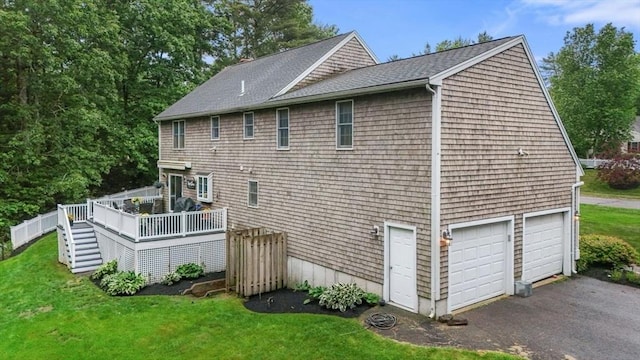 14 Cushman Lndg, Plympton, MA 02367 - back of property featuring driveway, a deck, a yard, an attached garage, and roof with shingles