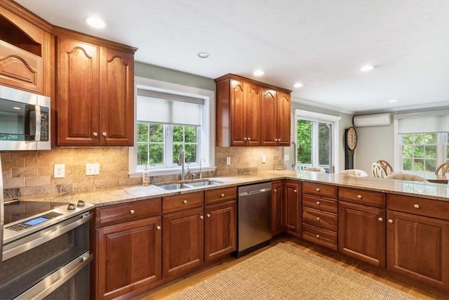 14 Cushman Lndg, Plympton, MA 02367 - kitchen featuring stainless steel appliances, healthy amount of natural light, a wall mounted air conditioner, light wood-style flooring, and recessed lighting