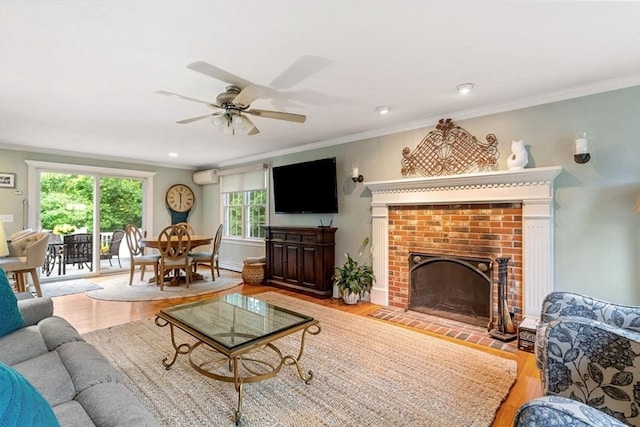 14 Cushman Lndg, Plympton, MA 02367 - living room with an AC wall unit, wood finished floors, ornamental molding, ceiling fan, and a fireplace