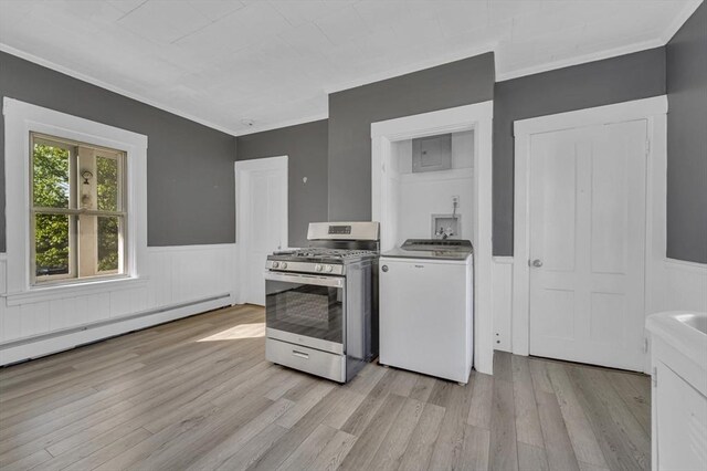 kitchen featuring washer / dryer, gas stove, a baseboard radiator, wainscoting, and light wood-type flooring