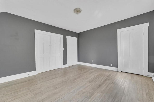 unfurnished room featuring wood finished floors and baseboards