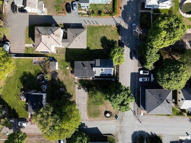 aerial view of property and surrounding area featuring nearby suburban area