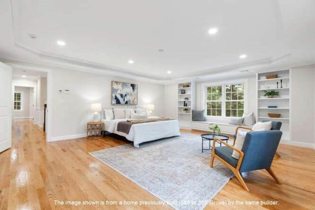 363 Grove St, Reading, MA 01867 - bedroom with light wood-type flooring, a tray ceiling, recessed lighting, and ornamental molding