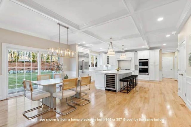 363 Grove St, Reading, MA 01867 - dining room with wine cooler, plenty of natural light, coffered ceiling, light wood finished floors, and beamed ceiling
