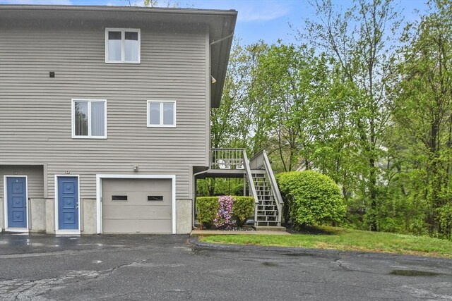 125 Chapin Rd Unit 3F, Hudson, MA 01749 - view of property exterior featuring stairway, a garage, and asphalt driveway