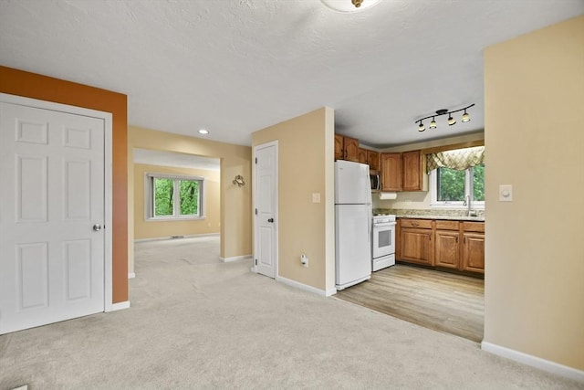 125 Chapin Rd Unit 3F, Hudson, MA 01749 - kitchen with white appliances, light carpet, baseboards, and light countertops