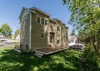22 Irene Cir, Waltham, MA 02453 - rear view of property with a lawn and a wooden deck
