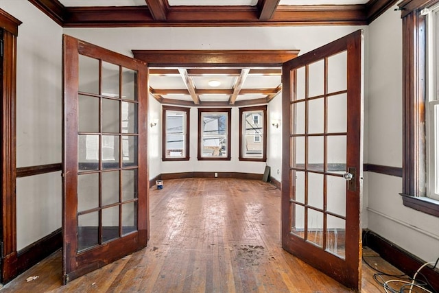 interior space featuring coffered ceiling, french doors, baseboards, and hardwood / wood-style flooring