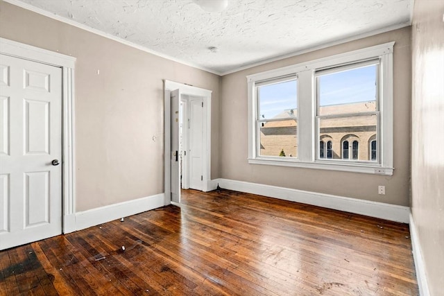 unfurnished bedroom featuring baseboards, a textured ceiling, and wood-type flooring
