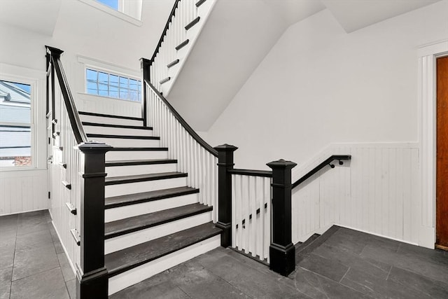 stairs featuring wainscoting