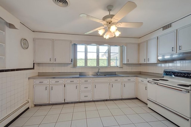 kitchen with white range with electric stovetop, stainless steel countertops, visible vents, a baseboard heating unit, and under cabinet range hood