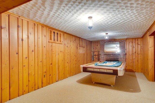 game room with carpet floors, crown molding, wood walls, and billiards