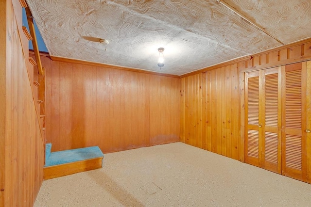 spare room featuring wood walls