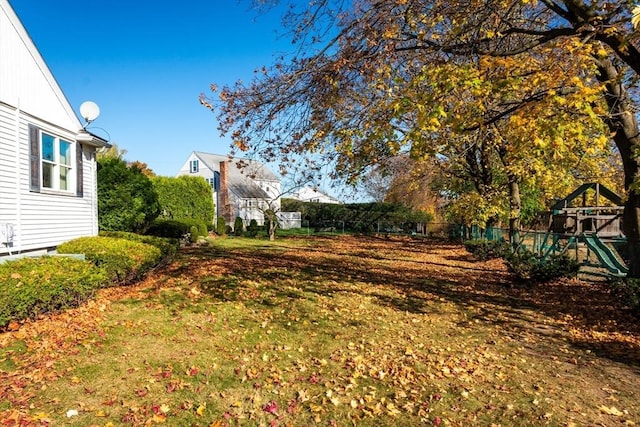 view of yard featuring a playground and fence