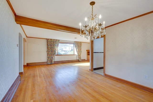 unfurnished room featuring arched walkways, baseboard heating, wood finished floors, and ornamental molding