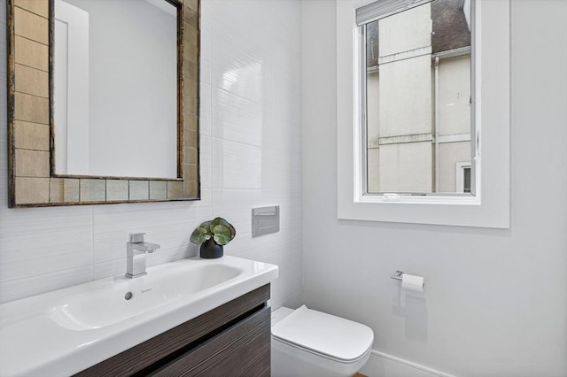 26 Salisbury Rd Unit 26, Newton, MA 02458 - bathroom featuring toilet, vanity, tile walls, and decorative backsplash