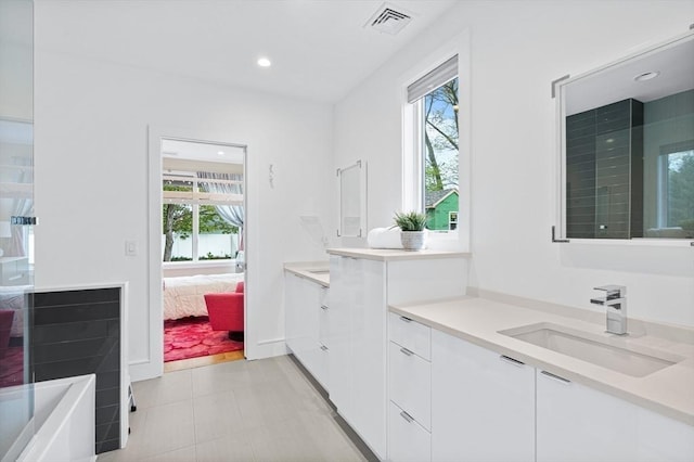 26 Salisbury Rd Unit 26, Newton, MA 02458 - ensuite bathroom with healthy amount of natural light, vanity, recessed lighting, and a tub to relax in