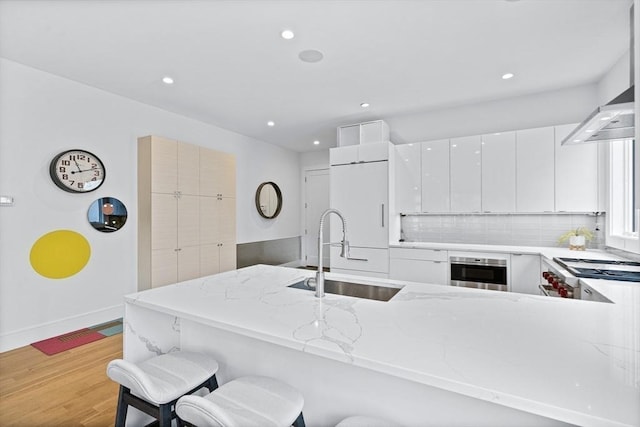 26 Salisbury Rd Unit 26, Newton, MA 02458 - kitchen with a sink, oven, light wood finished floors, recessed lighting, and backsplash