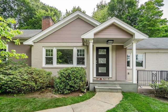 20 Lila Rd, Boston, MA 02130 - view of front facade featuring brick siding and a chimney