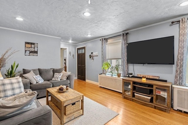 4 Ludington Rd, Worcester, MA 01602 - living area featuring crown molding, wood finished floors, radiator, recessed lighting, and a textured ceiling