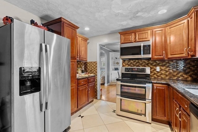 4 Ludington Rd, Worcester, MA 01602 - kitchen featuring stainless steel appliances, backsplash, light tile patterned floors, dark stone countertops, and recessed lighting