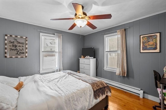 4 Ludington Rd, Worcester, MA 01602 - bedroom with multiple windows, a baseboard heating unit, wood finished floors, crown molding, and ceiling fan