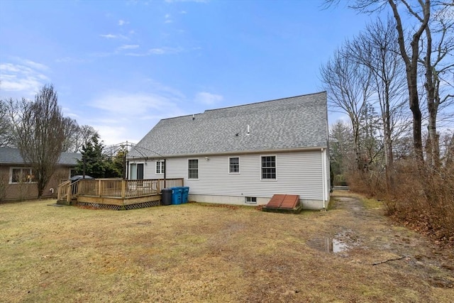 rear view of house with a yard, a shingled roof, and a wooden deck