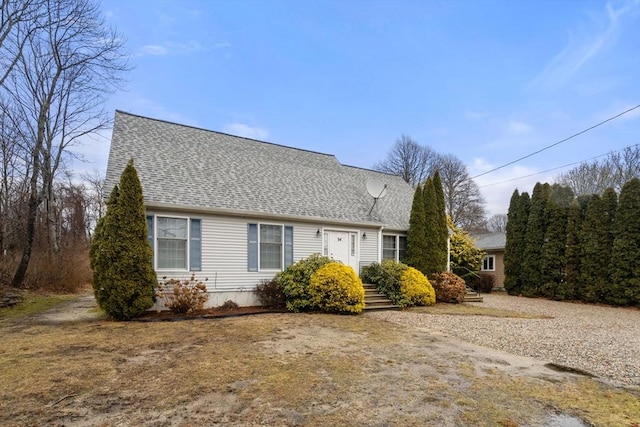 view of side of home featuring roof with shingles