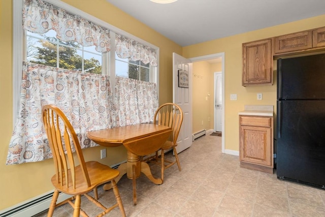 dining area featuring baseboards and a baseboard heating unit