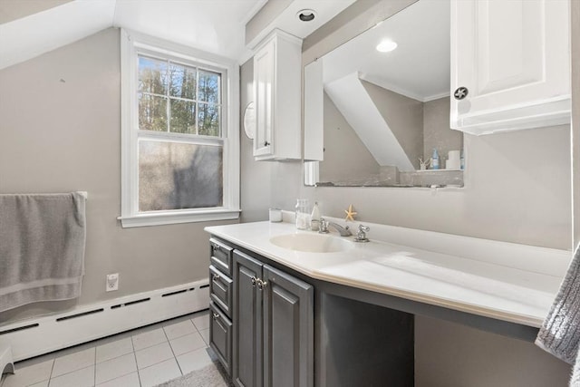 bathroom featuring tile patterned flooring, vaulted ceiling, vanity, and baseboard heating