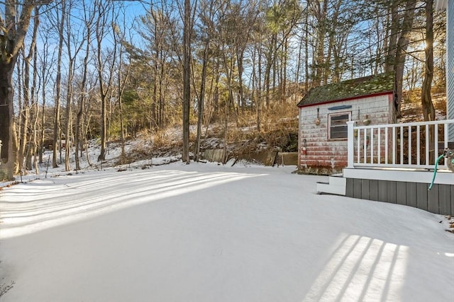 yard covered in snow with a deck