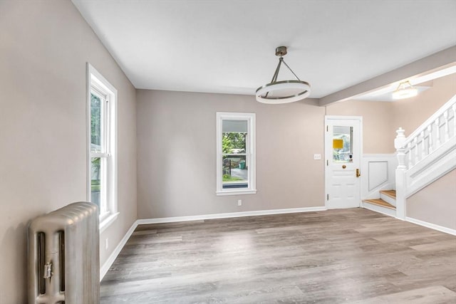 26 Olivine St, Chicopee, MA 01013 - entryway with radiator, stairs, and wood finished floors