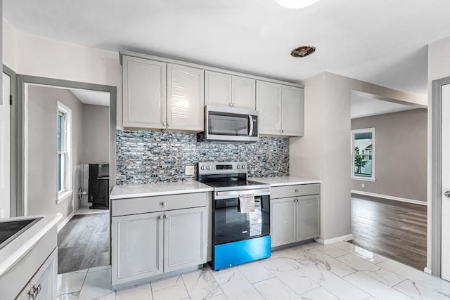 26 Olivine St, Chicopee, MA 01013 - kitchen featuring appliances with stainless steel finishes, gray cabinetry, and plenty of natural light